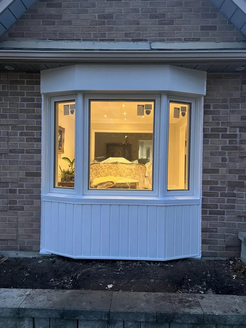 Newly installed bay window glowing at dusk, Markham