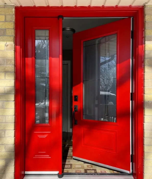 Red entry door on a home's front porch